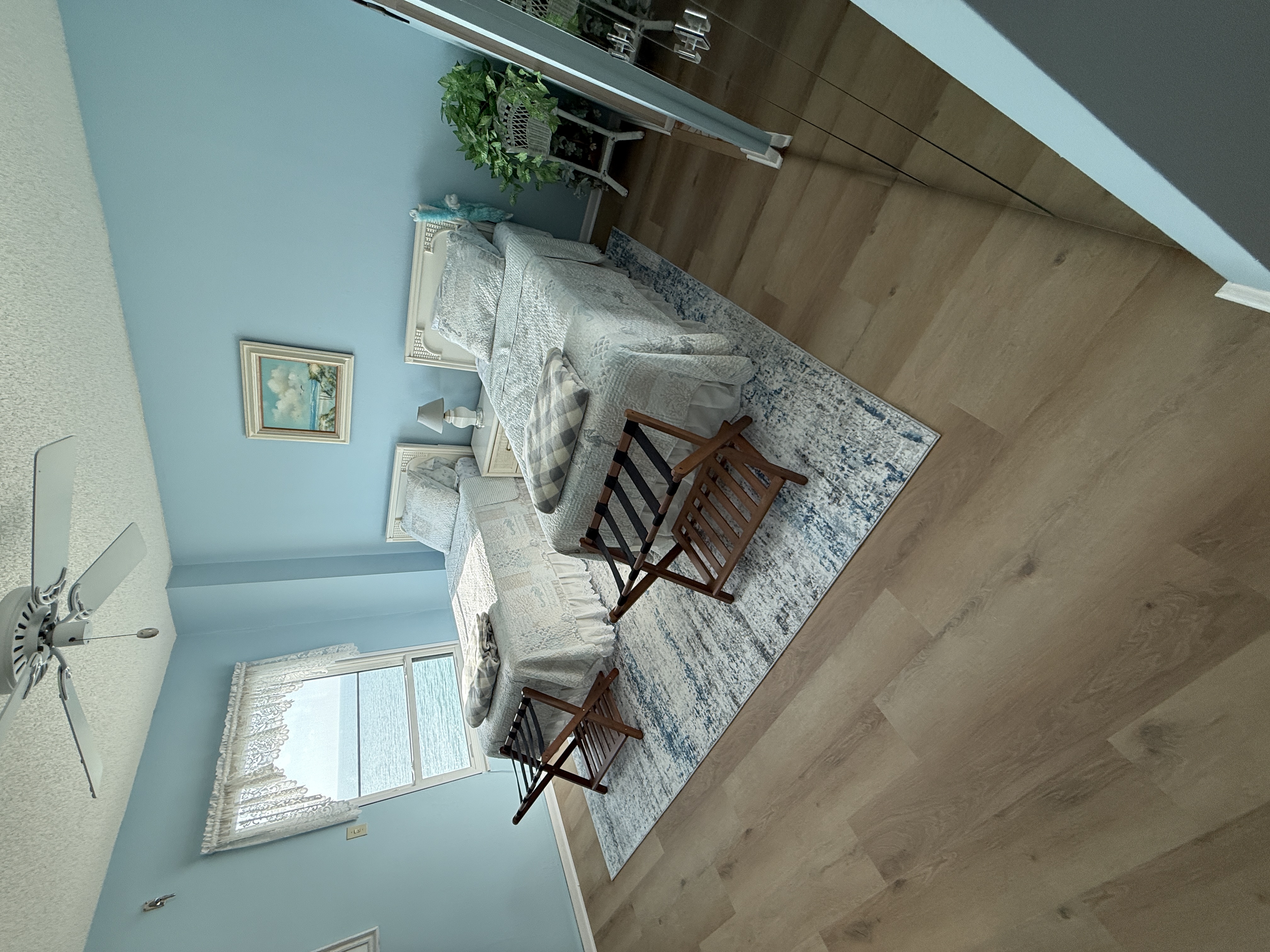 Guest bedroom with wicker chair and dresser